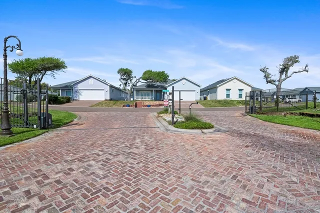 a front view of a house with a garden and yard