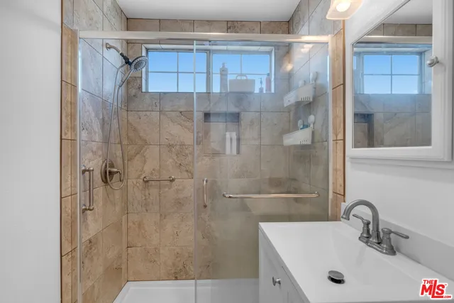 a bathroom with a sink and a shower