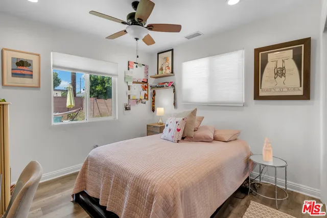 a bedroom with a bed and a large window