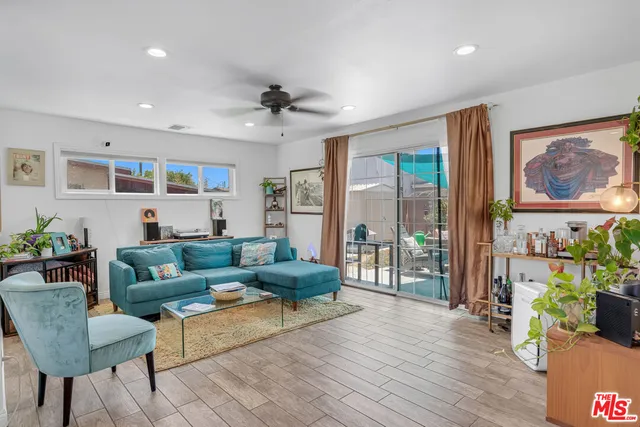 a living room with furniture and a painting on the wall