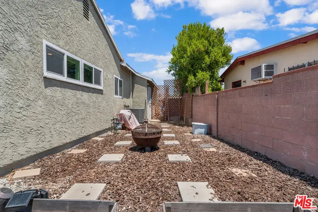 a backyard of a house with outdoor seating
