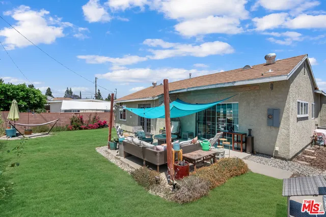 a building outdoor space with patio furniture and garden