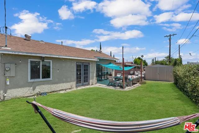a view of a house with backyard porch and sitting area