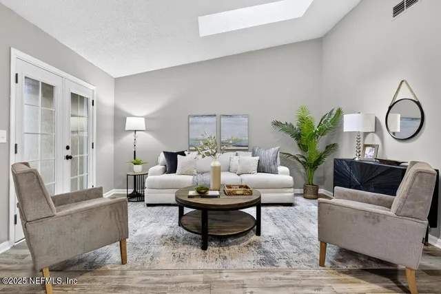 a living room with furniture and a potted plant