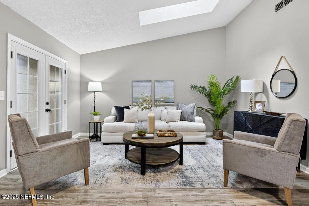 a living room with furniture and a potted plant