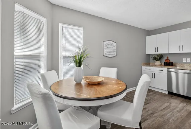 a view of a dining room with furniture and wooden floor