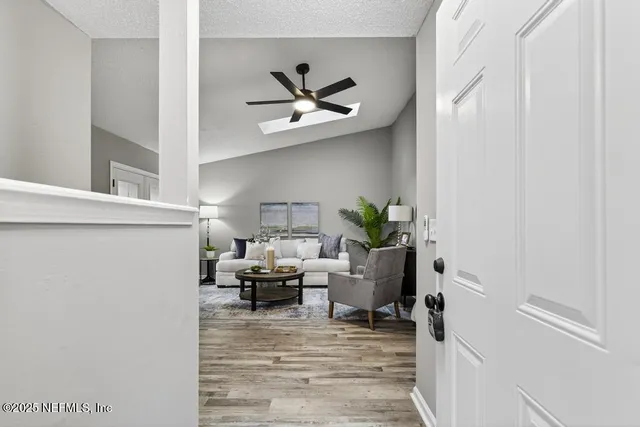 a living room with furniture and a chandelier