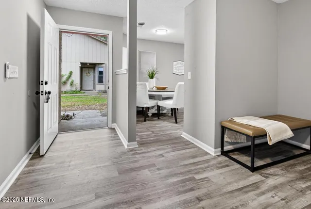 a bedroom with a bed and a view of living room