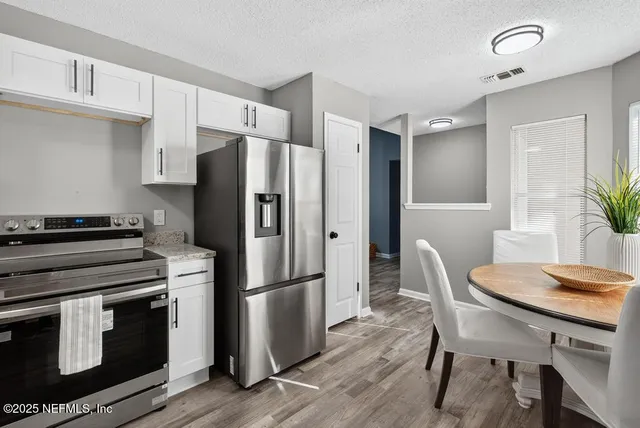 a kitchen with a refrigerator and a stove