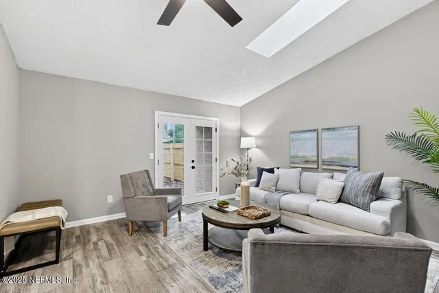 a living room with furniture and a wooden floor