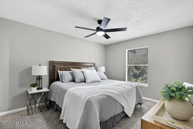 a bedroom with a bed and a potted plant