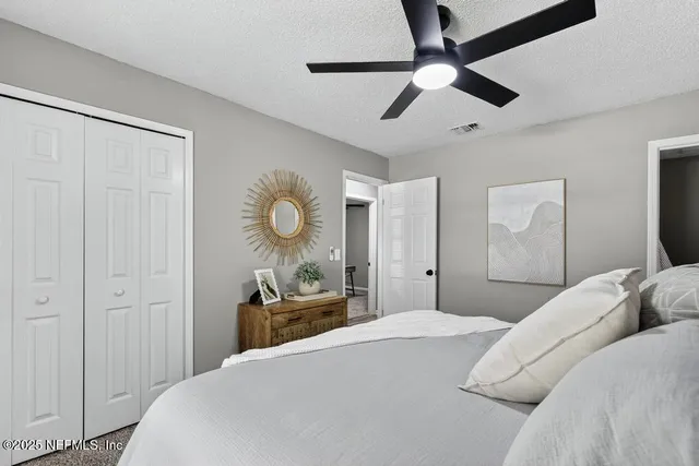 a bedroom with a bed and a chandelier