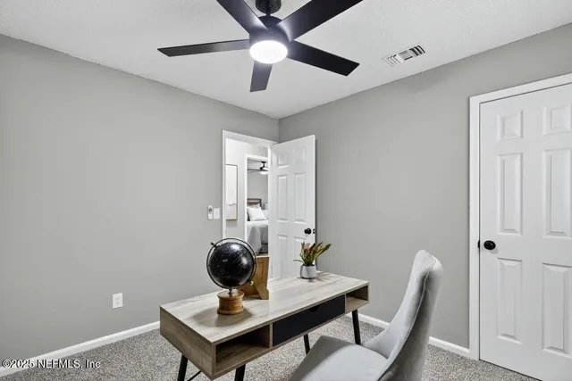 a view of a workspace with furniture