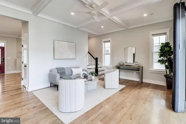 a view of a big room with wooden floor and windows