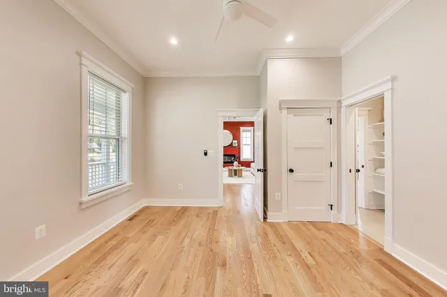 a spacious bedroom with a bed and a large window