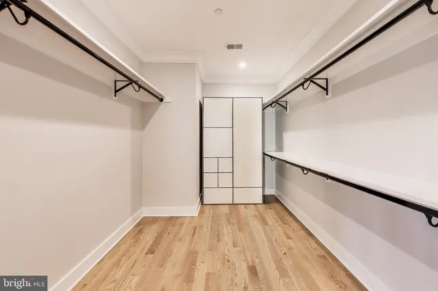 a spacious bathroom with a double vanity sink a mirror and a bathtub