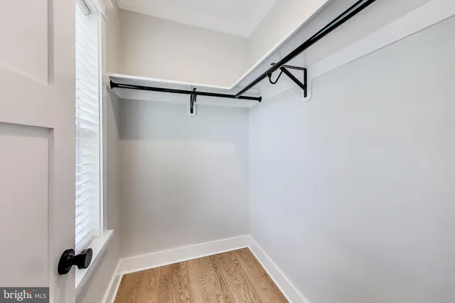 a bathroom with a double vanity sink toilet mirror and bathtub