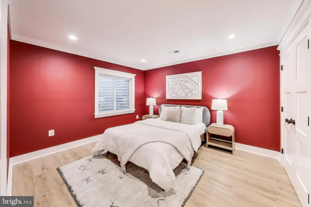 a view of a patio with couches and potted plants with wooden floor