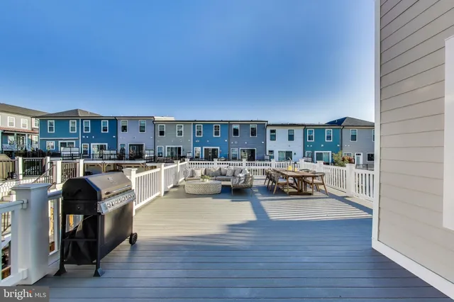 an empty room with a windows and ceiling fan