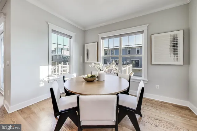 a view of a dining room with furniture and a potted plant