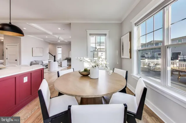a large kitchen with a table chairs refrigerator and microwave