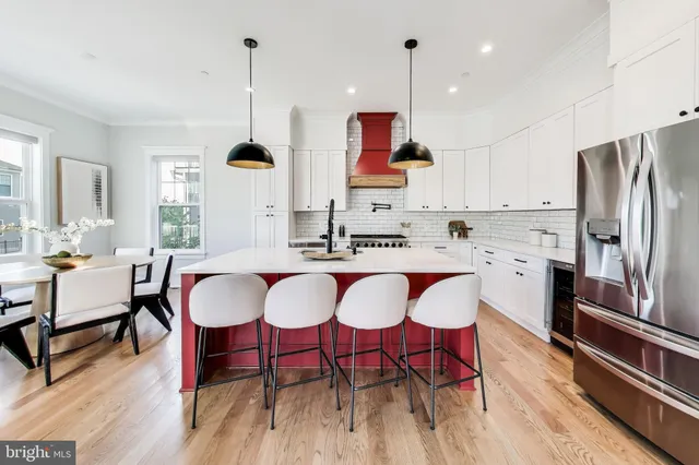 a kitchen with stainless steel appliances granite countertop a stove a sink and a white cabinets