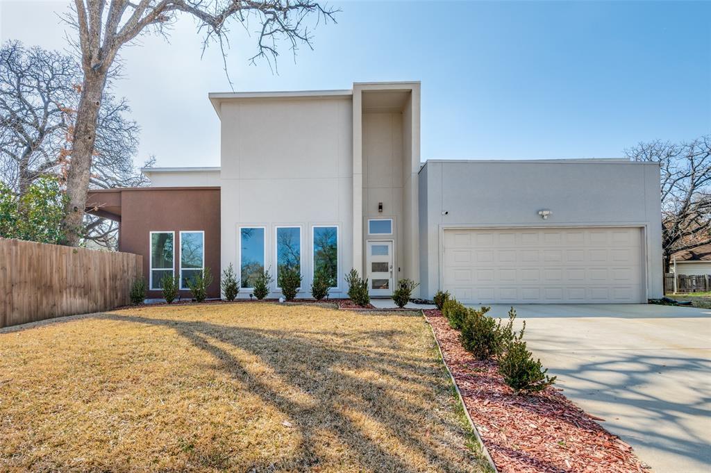 1620 Shadow Lane Irving, TX 75060 - Photo 1 of 1 Contemporary home with concrete driveway, stucco siding, and a garage