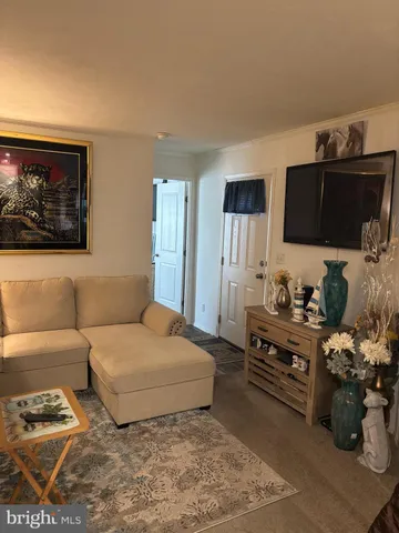 a bedroom with furniture and a flat screen tv