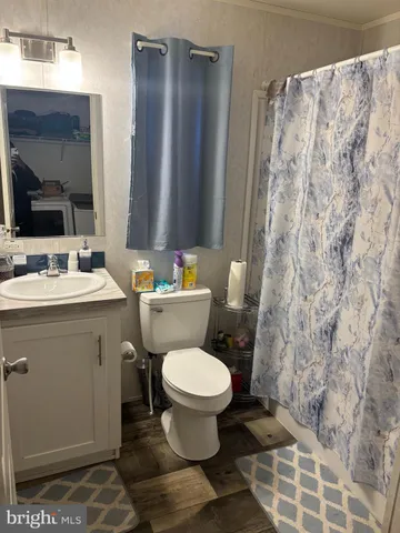 a bathroom with a sink toilet and a mirror
