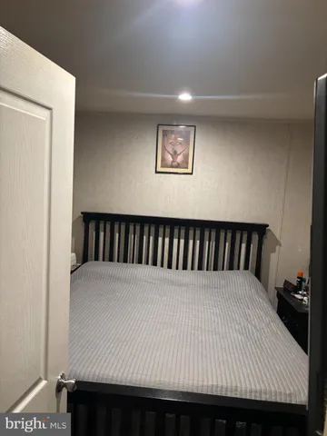 a bed sitting in a bedroom next to a cabinet