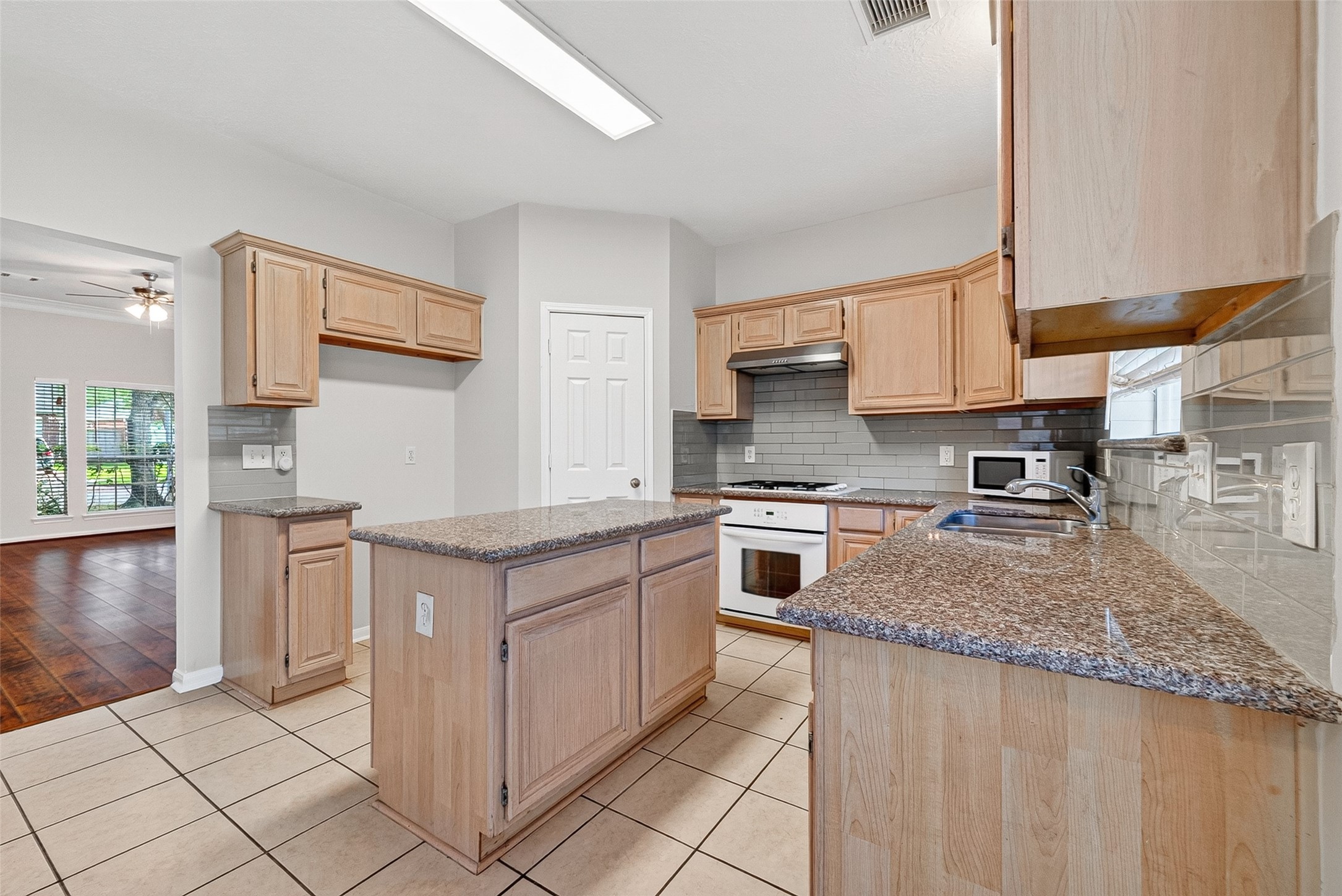 4539 Springfield Lakes Street Sugar Land, TX 77479 - Photo 9 of 34 a kitchen with stainless steel appliances granite countertop a stove a sink and a microwave
