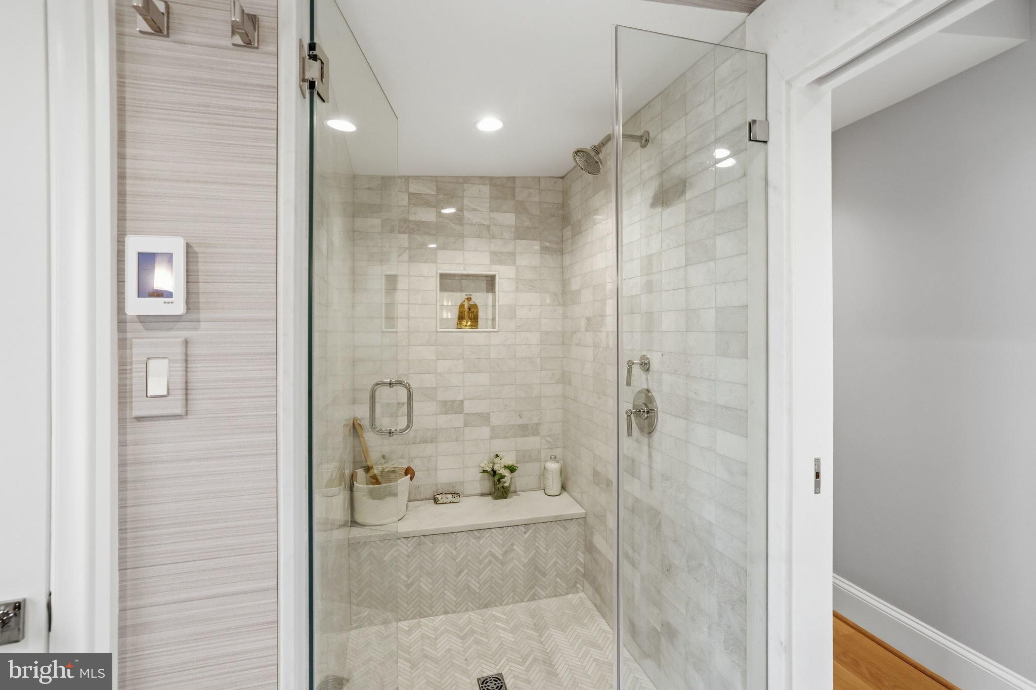 3418 Reservoir Road Northwest Washington, DC 20007 - Photo 20 of 33 a bathroom with a glass shower door