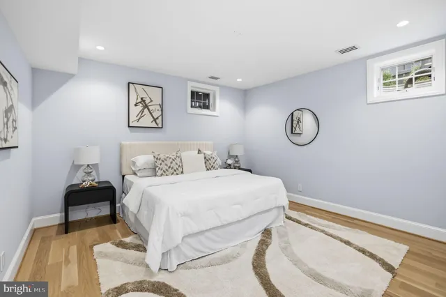 a bedroom with a bed and painting on the wall