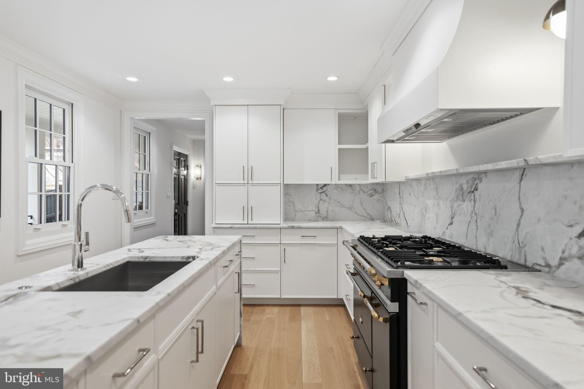 3418 Reservoir Road Northwest Washington, DC 20007 - Photo 6 of 33 a kitchen that has a sink a stove and cabinets