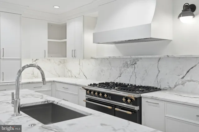 a kitchen with granite countertop a stove and a sink