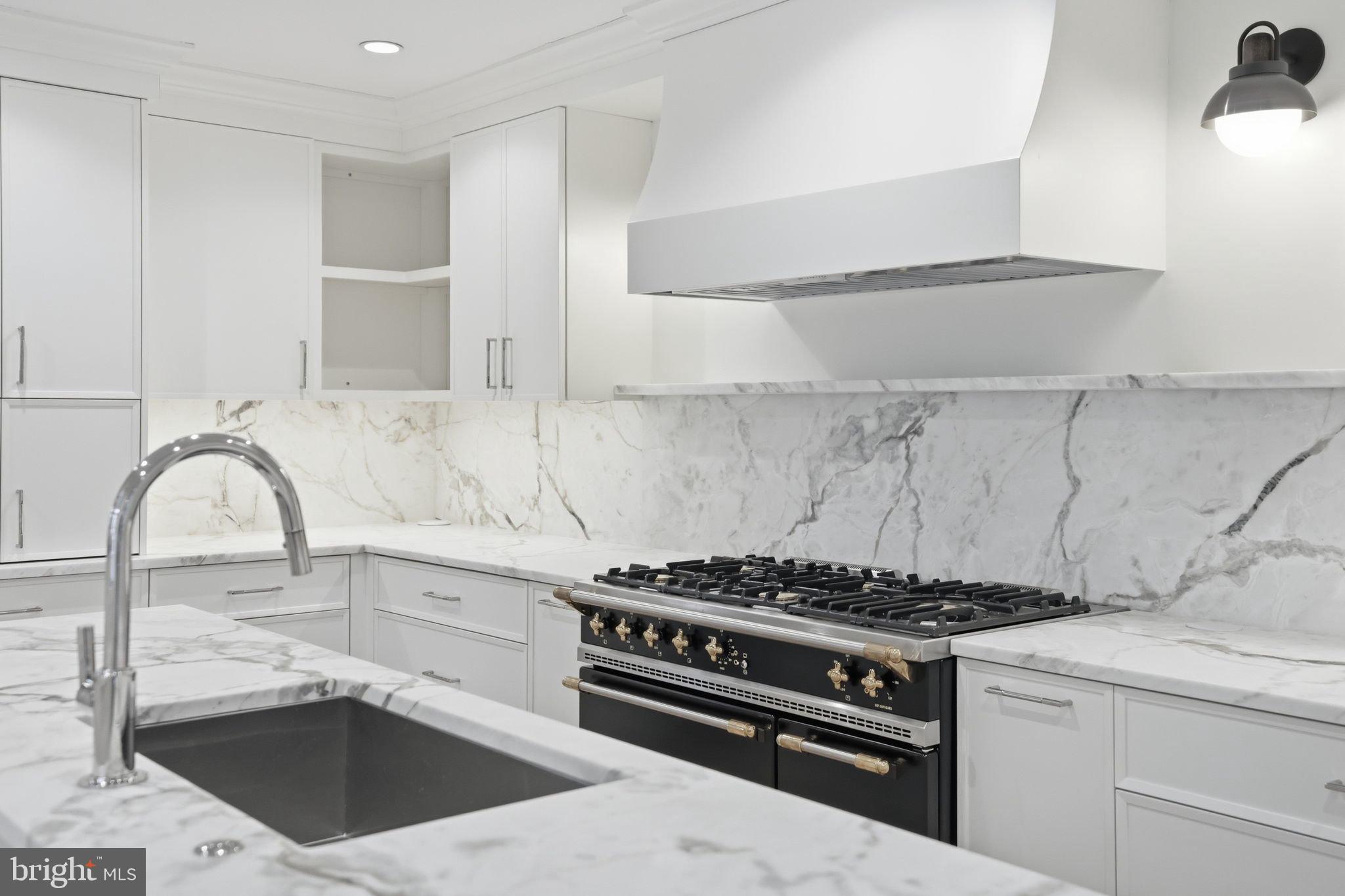 3418 Reservoir Road Northwest Washington, DC 20007 - Photo 7 of 33 a kitchen with granite countertop a stove and a sink