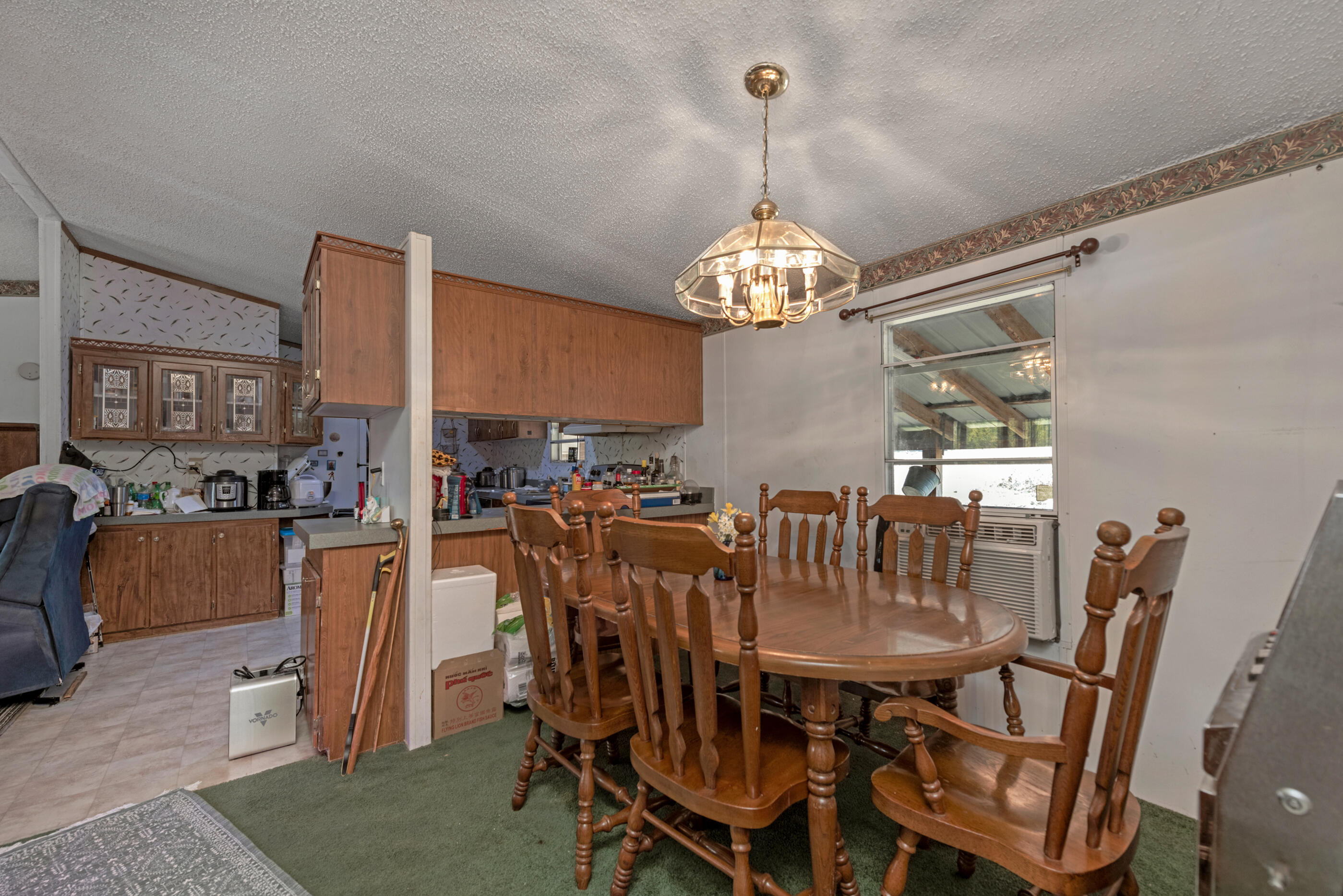 7189 Sherman Kennedy Road Baker, FL 32531 - Photo 11 of 29 a view of a dining room with furniture a chandelier and window