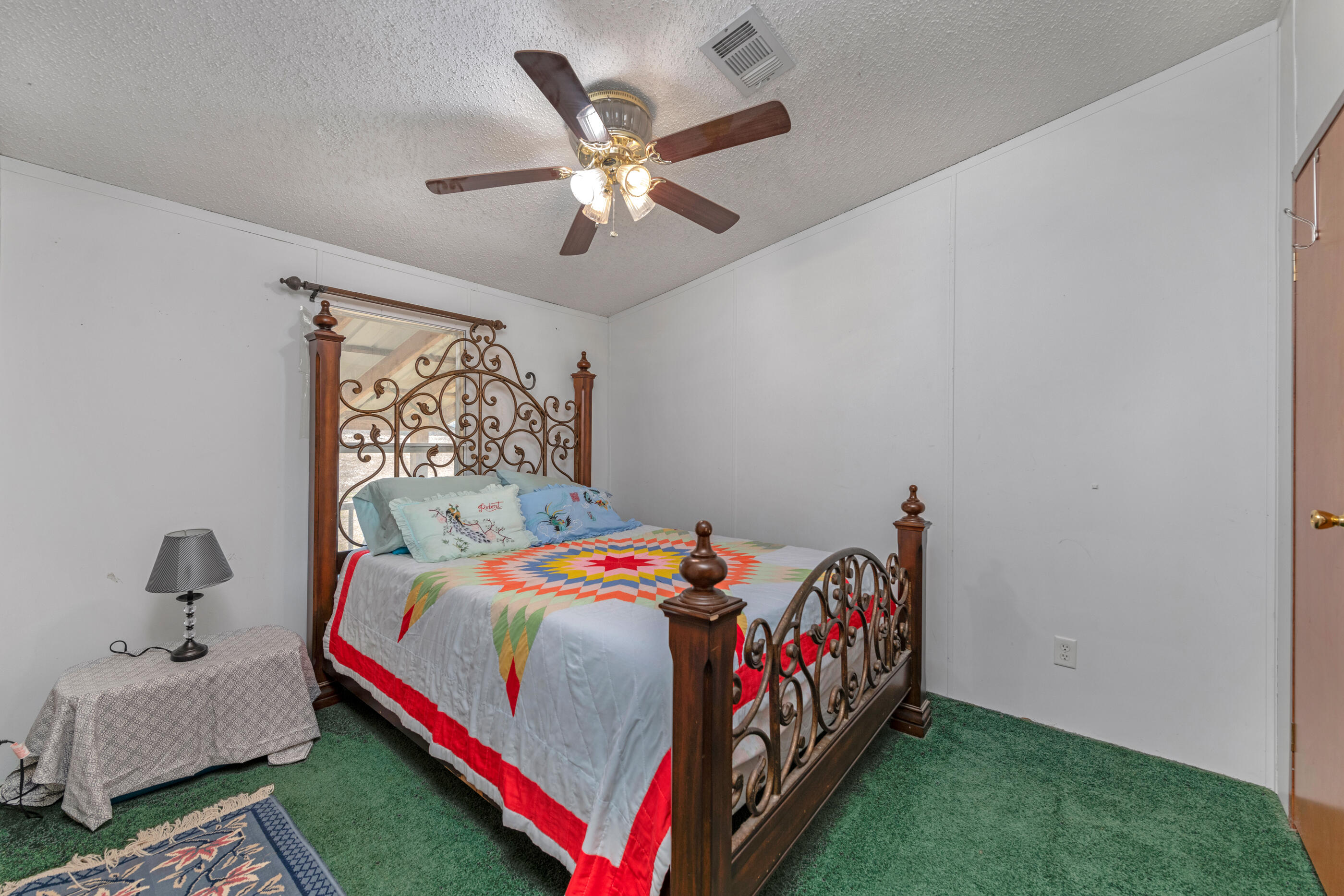 7189 Sherman Kennedy Road Baker, FL 32531 - Photo 12 of 29 a bedroom with a bed and a chandelier