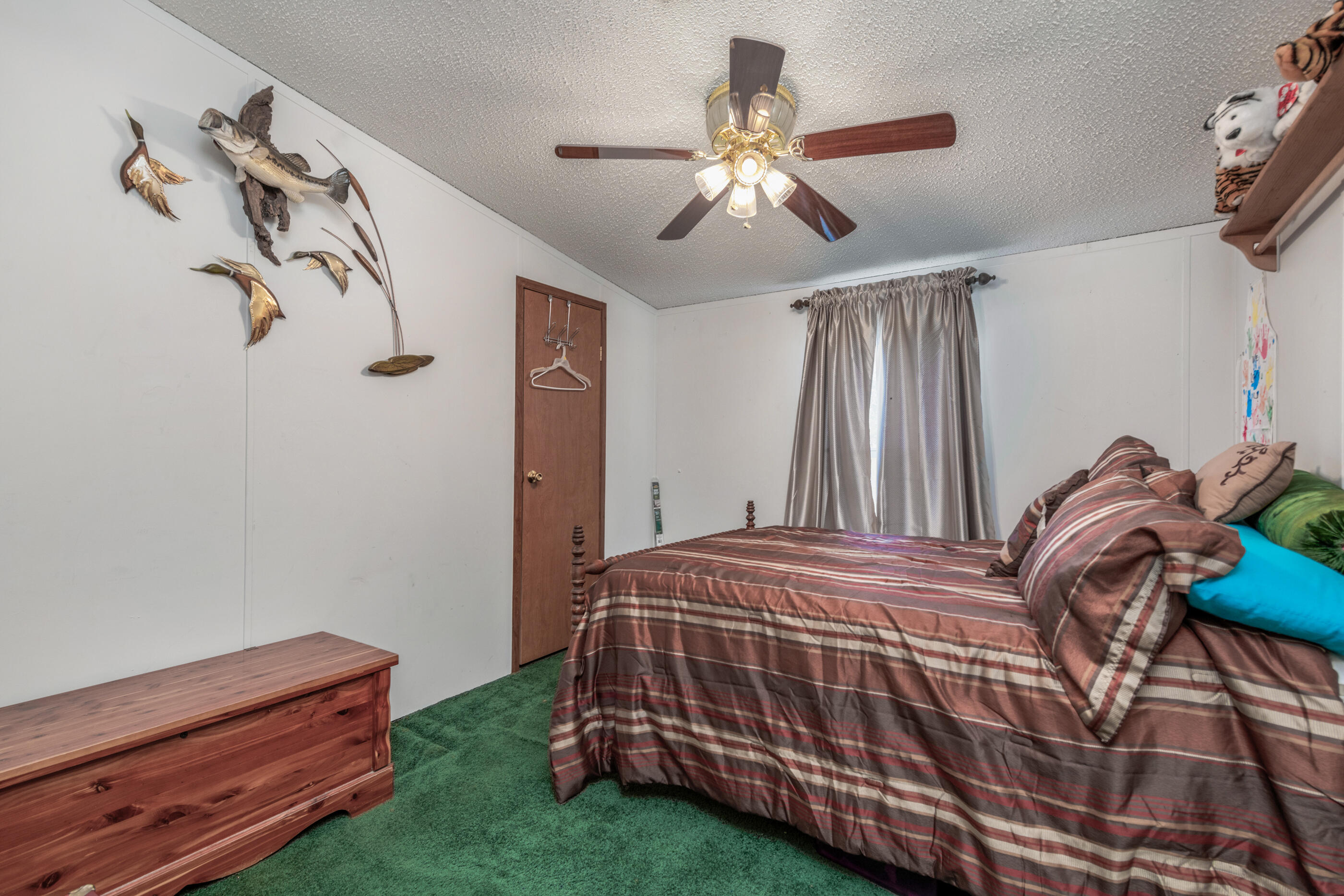 7189 Sherman Kennedy Road Baker, FL 32531 - Photo 13 of 29 a bedroom with a bed and a chandelier