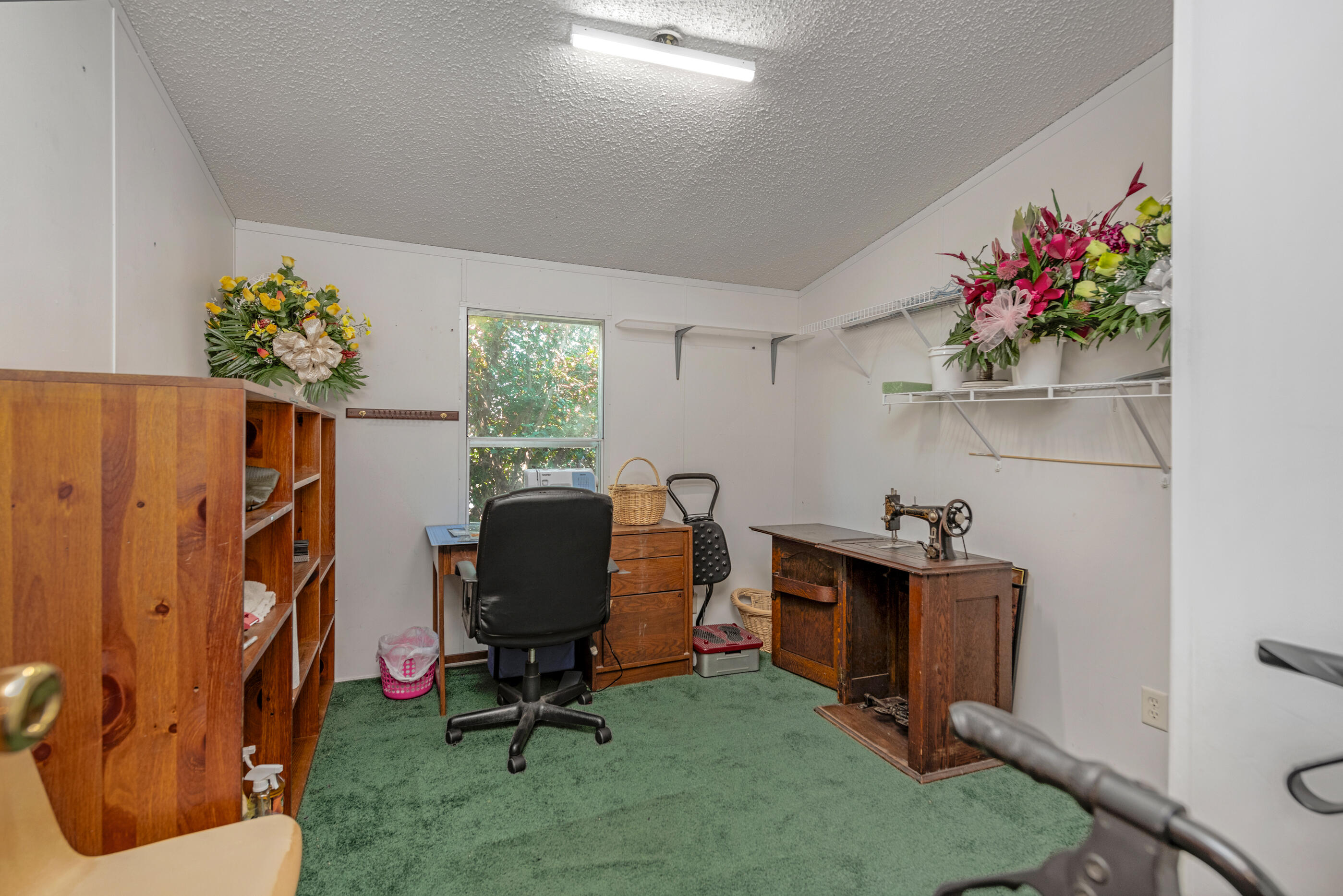 7189 Sherman Kennedy Road Baker, FL 32531 - Photo 14 of 29 a view of a workspace with furniture and a window