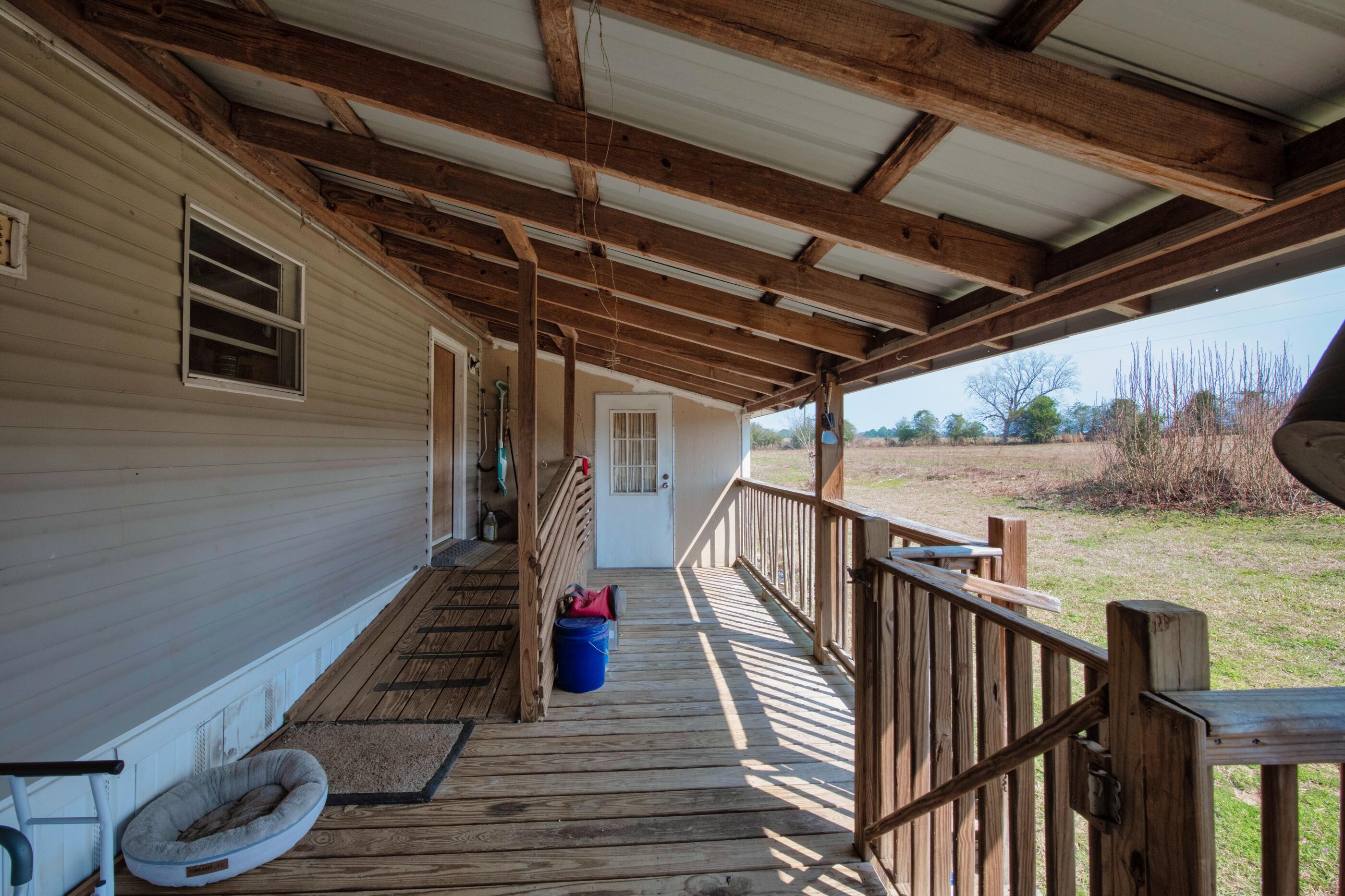7189 Sherman Kennedy Road Baker, FL 32531 - Photo 18 of 29 a view of balcony with wooden floor