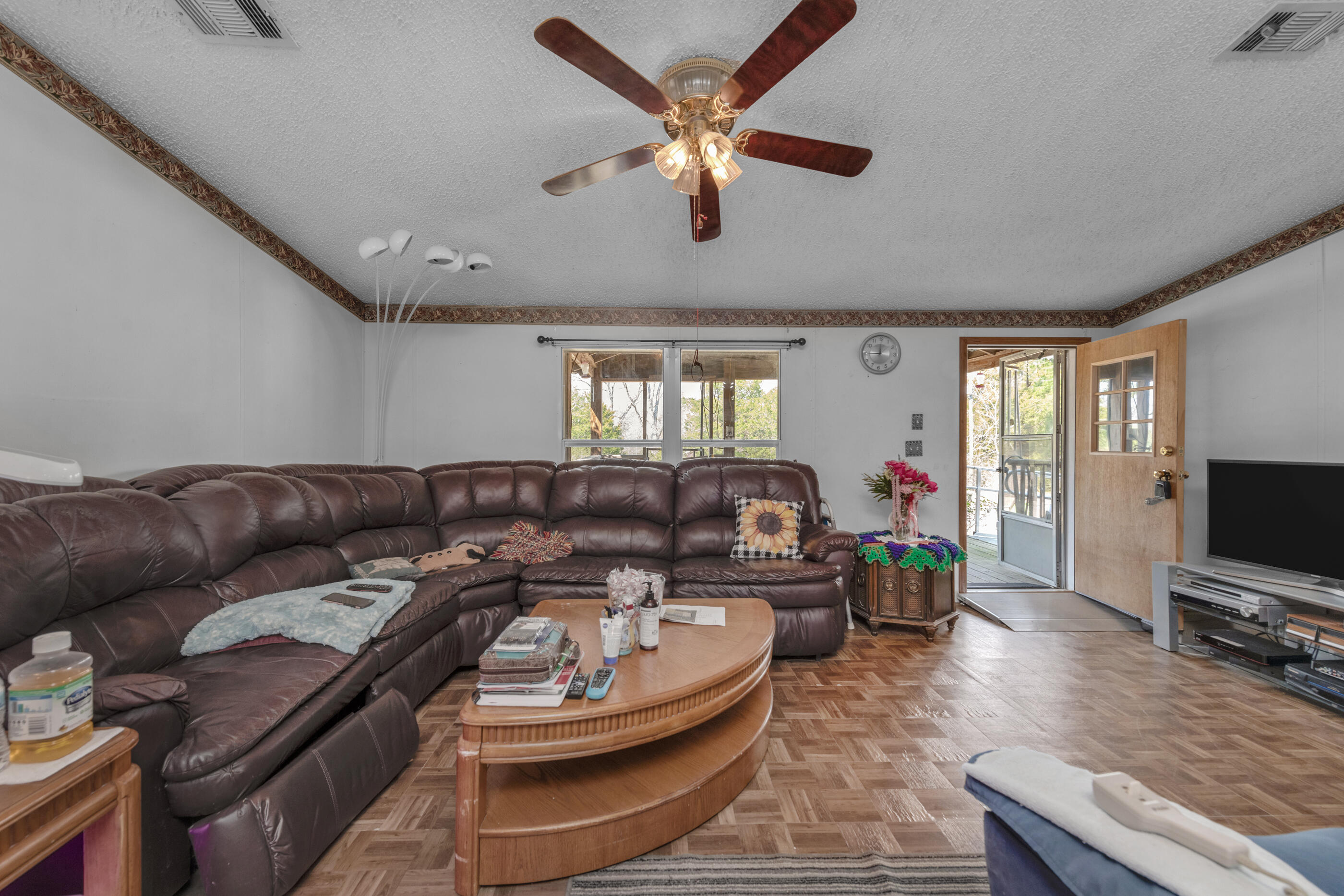 7189 Sherman Kennedy Road Baker, FL 32531 - Photo 8 of 29 a living room with furniture and a flat screen tv
