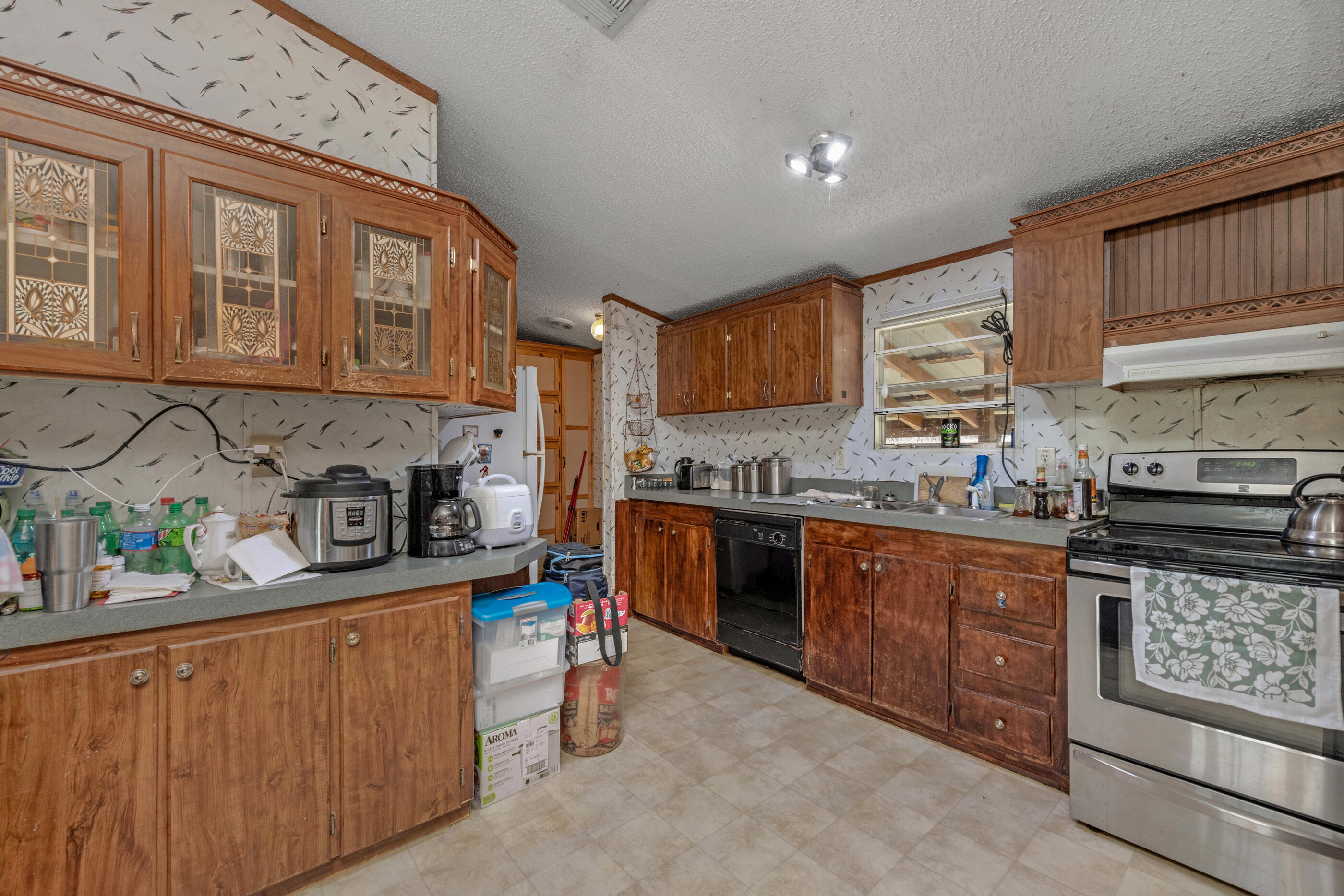 7189 Sherman Kennedy Road Baker, FL 32531 - Photo 9 of 29 a kitchen with stainless steel appliances granite countertop a stove top oven a sink dishwasher and cabinets