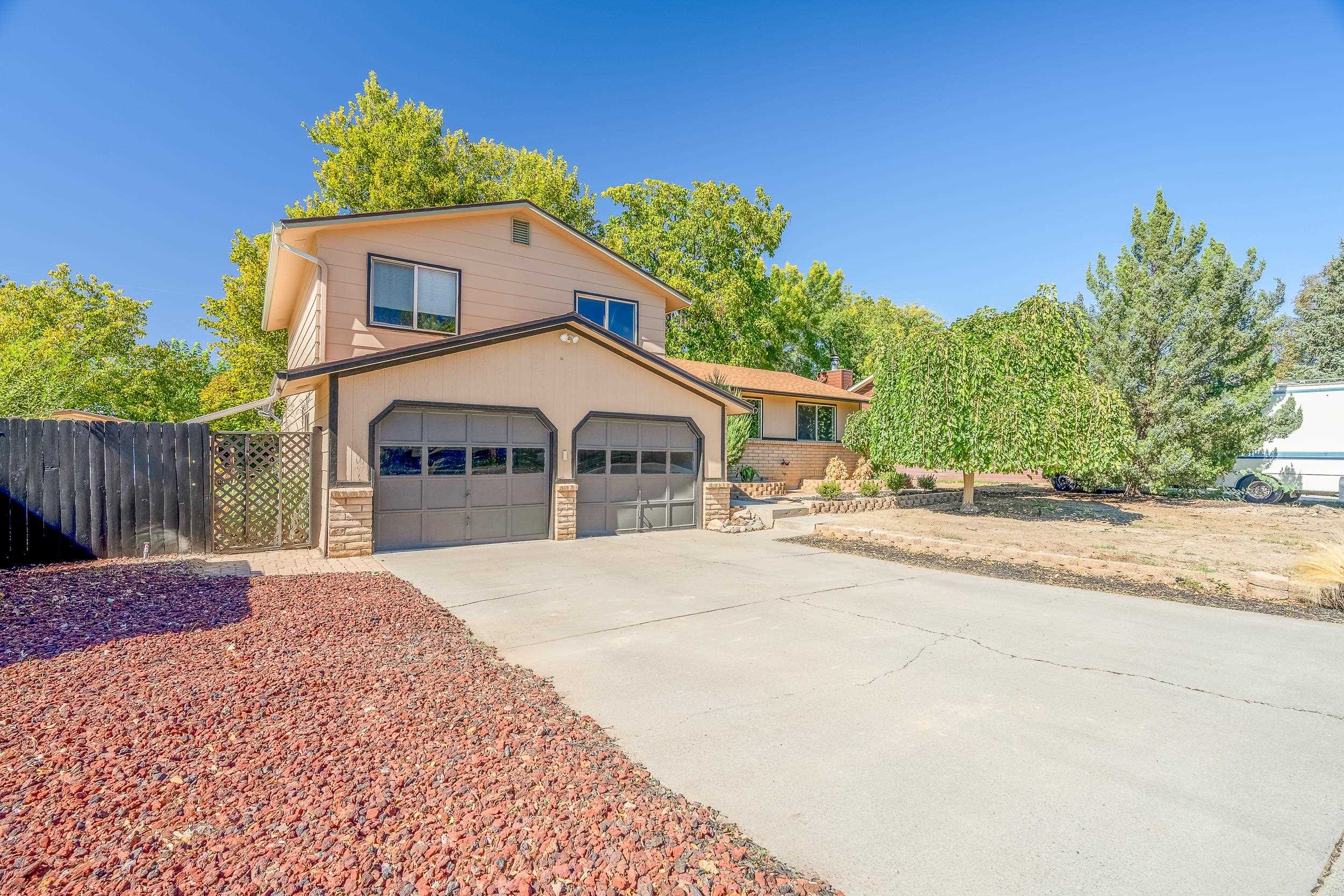 623 Broken Spoke Road Grand Junction, CO 81504 - Photo 1 of 27 a front view of a house with a yard and garage