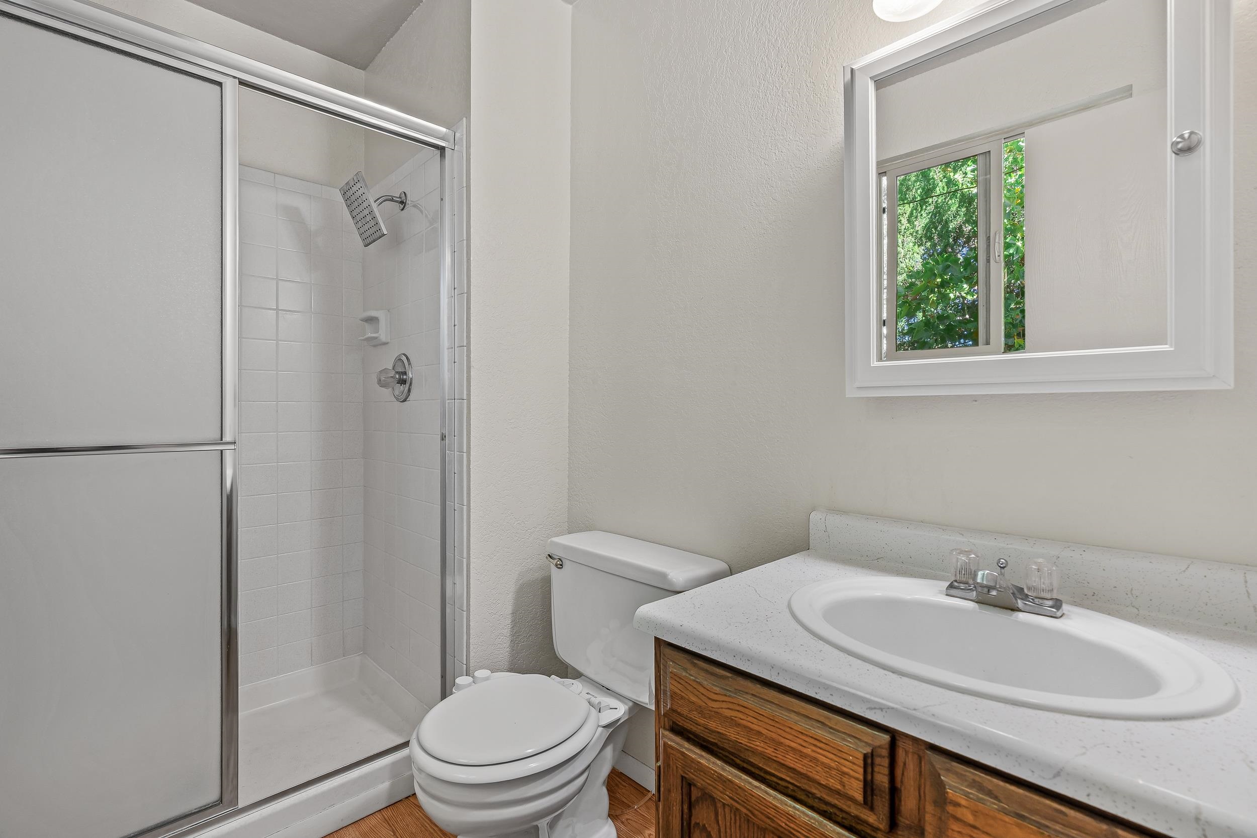 623 Broken Spoke Road Grand Junction, CO 81504 - Photo 14 of 27 a bathroom with a granite countertop sink toilet a mirror and shower