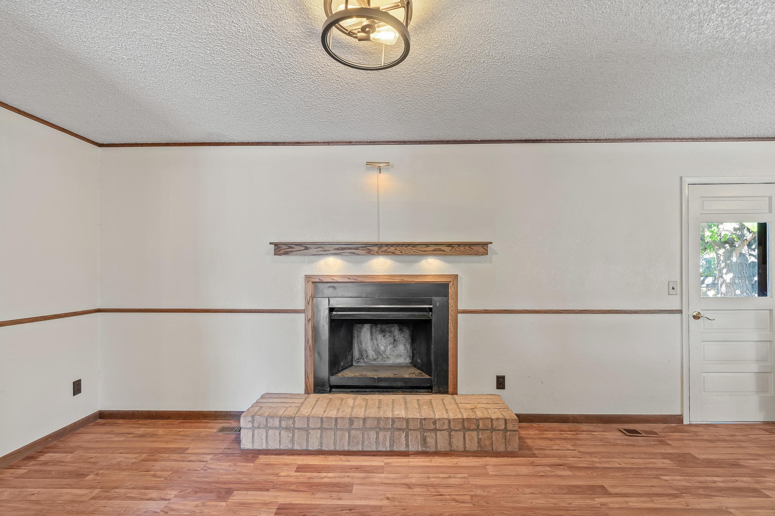 623 Broken Spoke Road Grand Junction, CO 81504 - Photo 10 of 27 a white house with a fireplace in it
