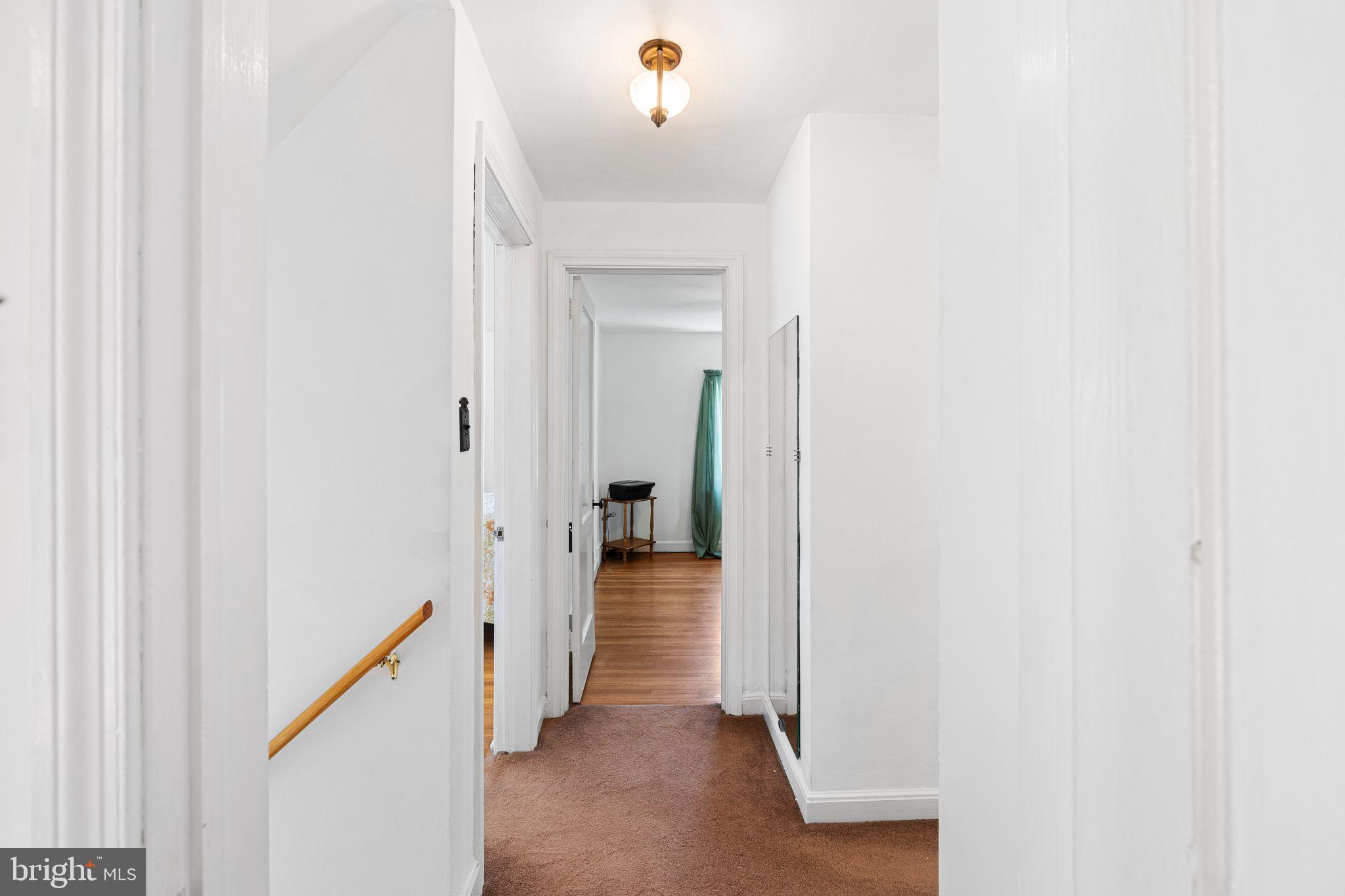 142 Rambling Way Springfield, PA 19064 - Photo 14 of 33 a view of a hallway with wooden floor and staircase