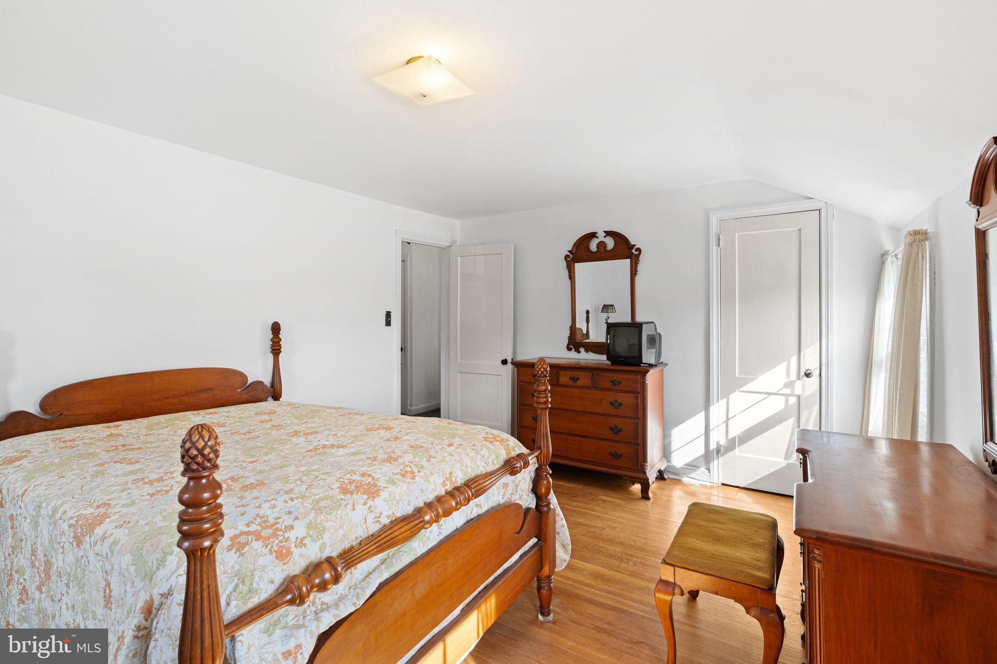 142 Rambling Way Springfield, PA 19064 - Photo 16 of 33 a bedroom with a bed and a table in it