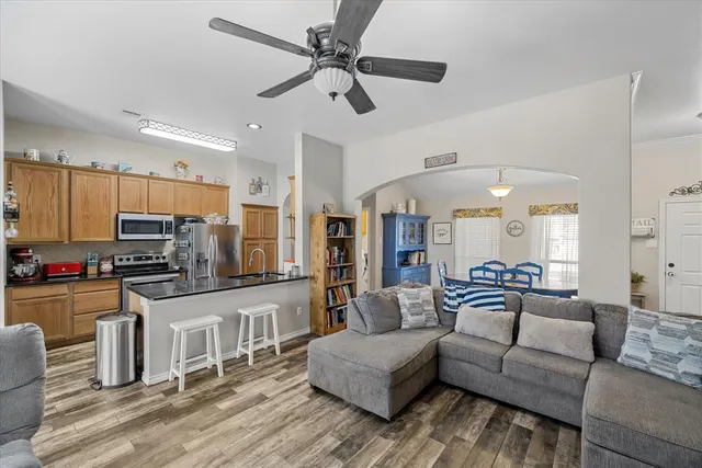 a living room with furniture and a wooden floor