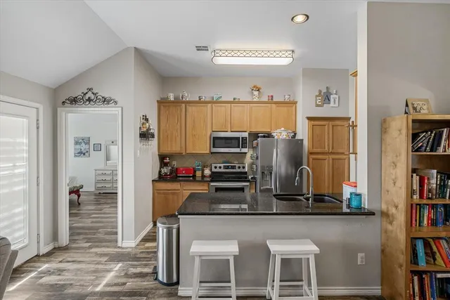 a kitchen with stainless steel appliances granite countertop a refrigerator and stove